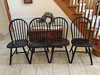 Four black Windsor chairs front view