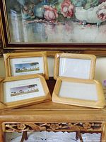 Front view of four matching light oak photo frames
