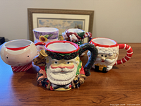 Front view of all five holiday mugs