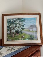 Front view of framed pastel painting on surface