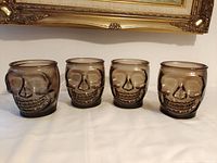 Front view of four smoky skull tumblers