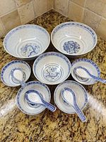 Full set of bowls and spoons displayed on countertop