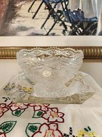Footed cut crystal bowl on square underplate, label visible