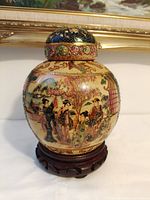 Full view of ginger jar with lid on wooden stand