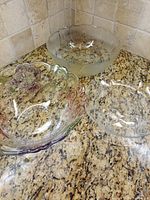 All three glass pieces: large frosted bowl, iridescent floral bowl, clear platter