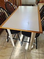 Dining table top and two chairs visible