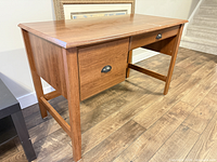 Desk three-quarter view showing overall design and leg structure