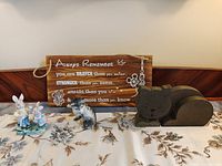 Group shot showing all four items: wooden sign, wood cat, ceramic cat, ceramic rabbit pair