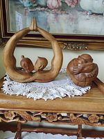 Both sculptures on table showing size relation and overall appearance