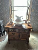 Front view of oak washstand with mirror and porcelain set displayed on top