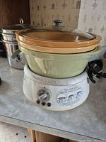 Overall view of slow cooker with nested crocks on countertop