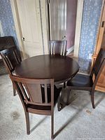 Overall view of round table with four chairs