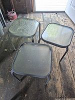 All three square patio tables on wooden floor