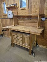 Front three-quarter view showing entire workbench with hutch and vise