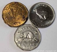 Fronts of three Canadian nickels showing 1943 V, 1967 rabbit, 1958 beaver