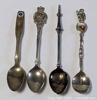 Front view of all four souvenir spoons