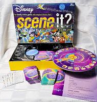 Opened box displaying board, DVD, card decks, pieces