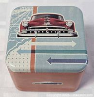 Top view of Fossil watch tin with vintage car graphic