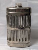 full view of flask front showing metal sleeve with vertical slots