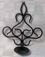Full view of metal scrollwork candle holder front