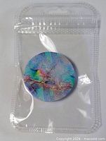 Front of sealed package showing multicolor PopSocket