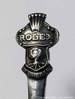 Handle finial showing Rolex crown, ROLEX lettering, Bucherer emblem