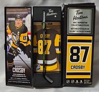 Mini hockey stick in open case beside outer sleeve showing Sidney Crosby image