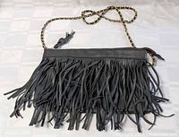 Full view of purse with chain strap laid flat