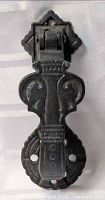 Full view of black cast iron door knocker