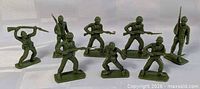 Group shot of eight olive green plastic soldiers