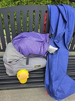 Sleeping bag in compression sack, blue fabric, yellow candle
