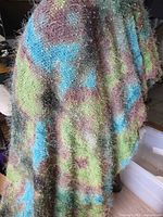 Full view of folded eyelash knit fabric showing colours and texture