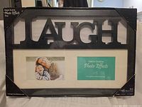 Front of packaged Green Earth "LAUGH" photo frame