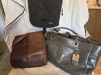 Overall view of gray tote, brown messenger, black messenger