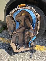 Front view showing main compartments, Outbound logo, blue trim, daisy chains and straps