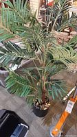 Full view of artificial palm plant in pot