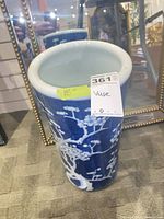 Full view of cylindrical blue and white porcelain floor vase showing pattern and size
