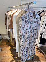 Full view of chrome garment rack with clothes to show size (contents not included)