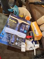 Lot overview with ProGrip kit, bucket, spray bottles, gloves, brush
