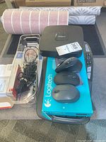 Lot overview with Logitech keyboards, boxed items, mice, cables tray