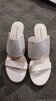 Top view of both sandals displaying perforated and patent straps, color and condition