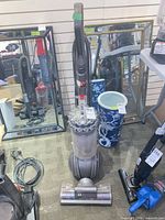 Full view of Dyson upright vacuum standing with hose and wand attached