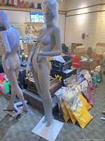 Full view of mannequin on white square base