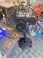 Full view of Honeywell pedestal fan showing blades, grille, column and base