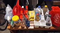 Overall lot on bench with cleaners, wipes, dustpan, caddy