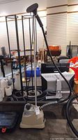 Full view of Jiffy J-2000 garment steamer with base, pole and hose