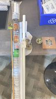 wrapped curtain rods and loose white rods with brackets and finials