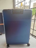 Front of blue gradient MAT hard-shell suitcase on spinner wheels