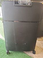Front view of black ribbed hard-side suitcase