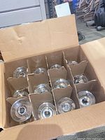 Cardboard box holding 12 wine glasses in dividers